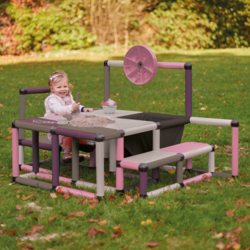 Child playing with sand on a play table